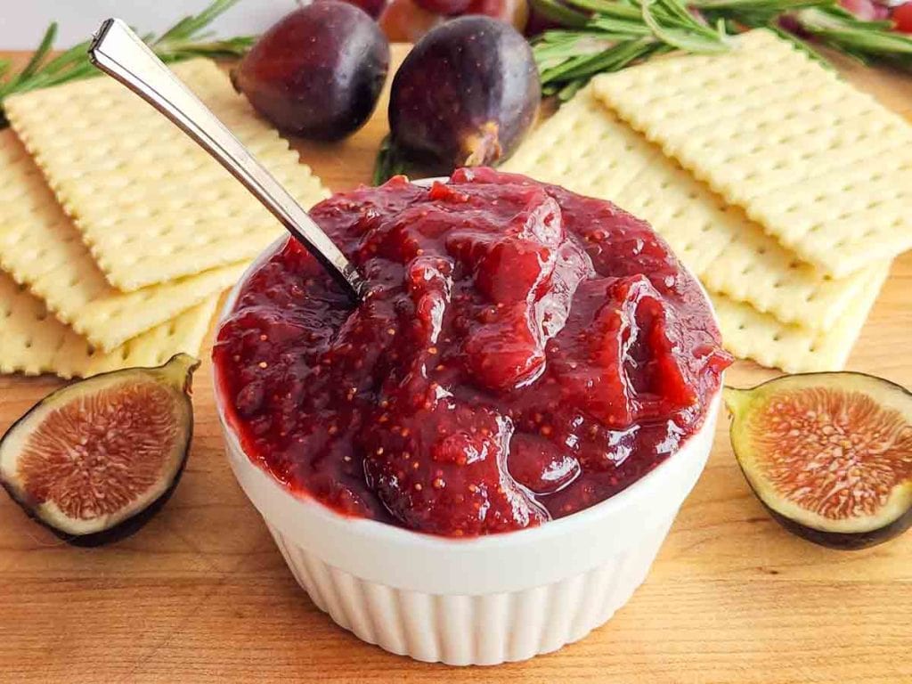 Fig jam with a spoon in a white bowl